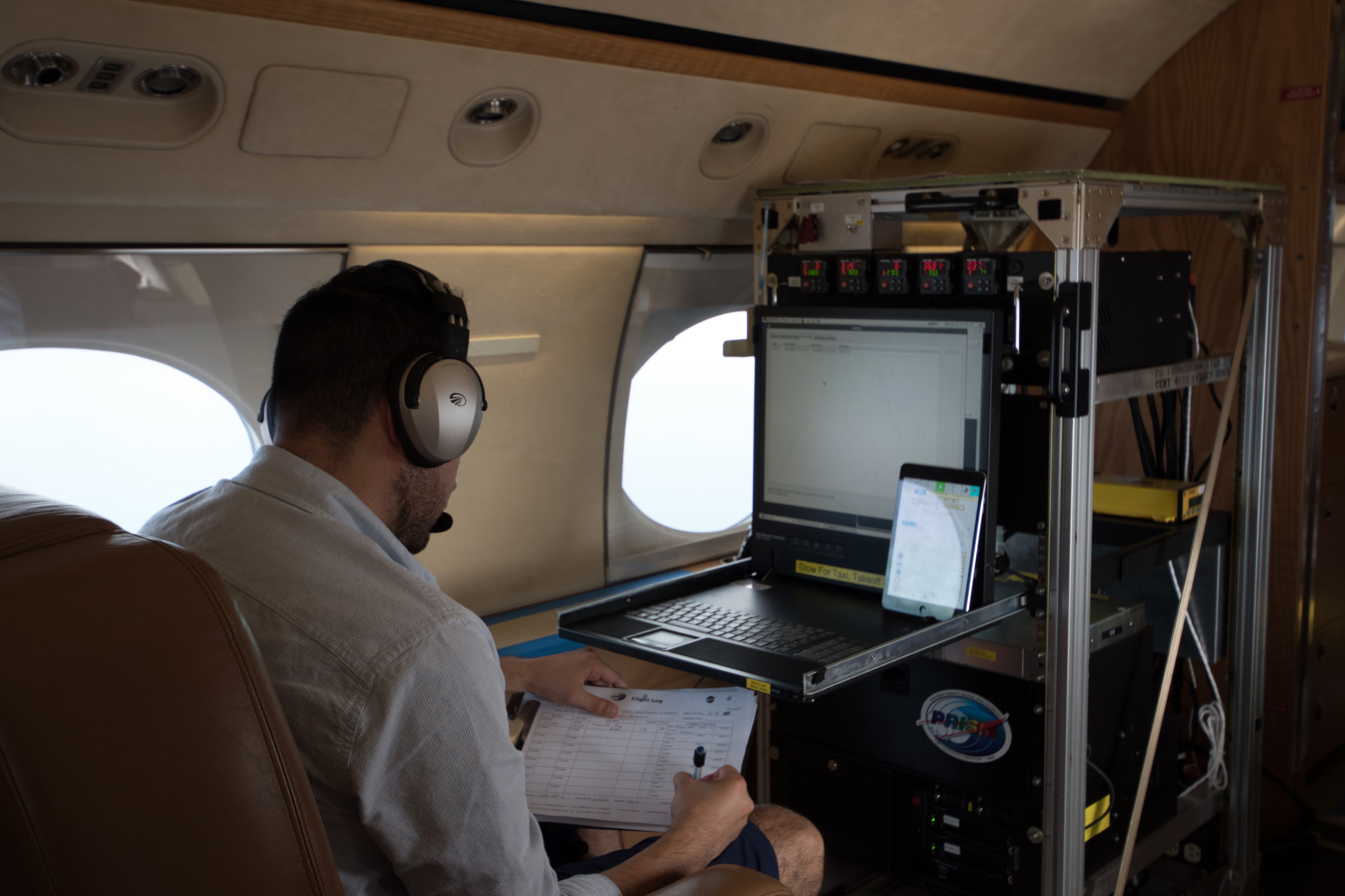 A NASA engineer operations the PRISM instrument aboard the G4