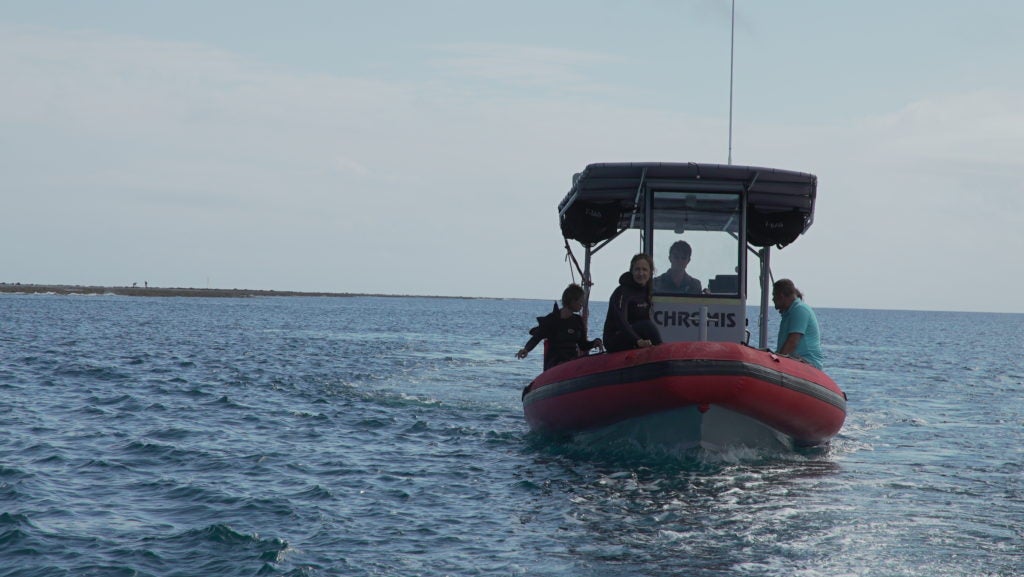 Scientists on a boat heading to a survey site