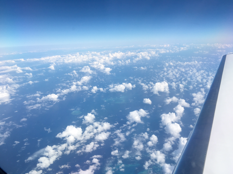 A view from above the clouds taken out the window of the G4 airplane