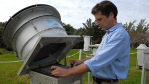 BIOS scientist Andrew Peters checks environmental monitoring equipment on the BIOS campus in Bermuda