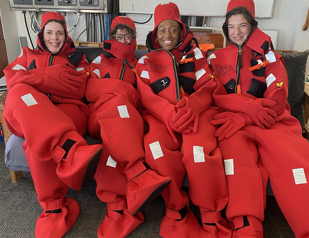 the group wears survival gear during a safety briefing