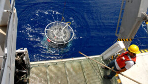 A scientist watches the CTD rosette submerge off the back deck of the research vessel Atlantic Explorer