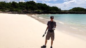 Shane Antonition stands on the beach during a survey for microplastics