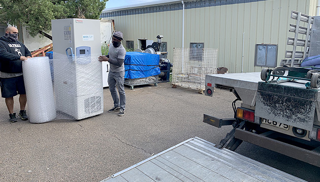 In January, BIOS removed an ultra-low temperature freezer (shown here being wrapped and readied for transport) from its research vessel, the Atlantic Explorer, and loaned it to the Bermuda Government's Ministry of Health to store incoming doses of the COVID-19 vaccine. Unlike other vaccines, the Pfizer COVID vaccine must be kept below refrigeration temperatures, which means that specialized equipment—such as this ultra-low freezer—are required to protect the quality of the vaccine doses.